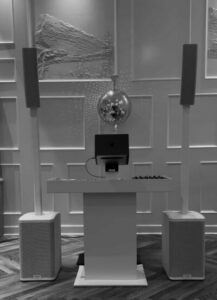 Revolution DJ edmonton white set up. Features a disco ball, dj podium, and 2 pa speakers with subs.